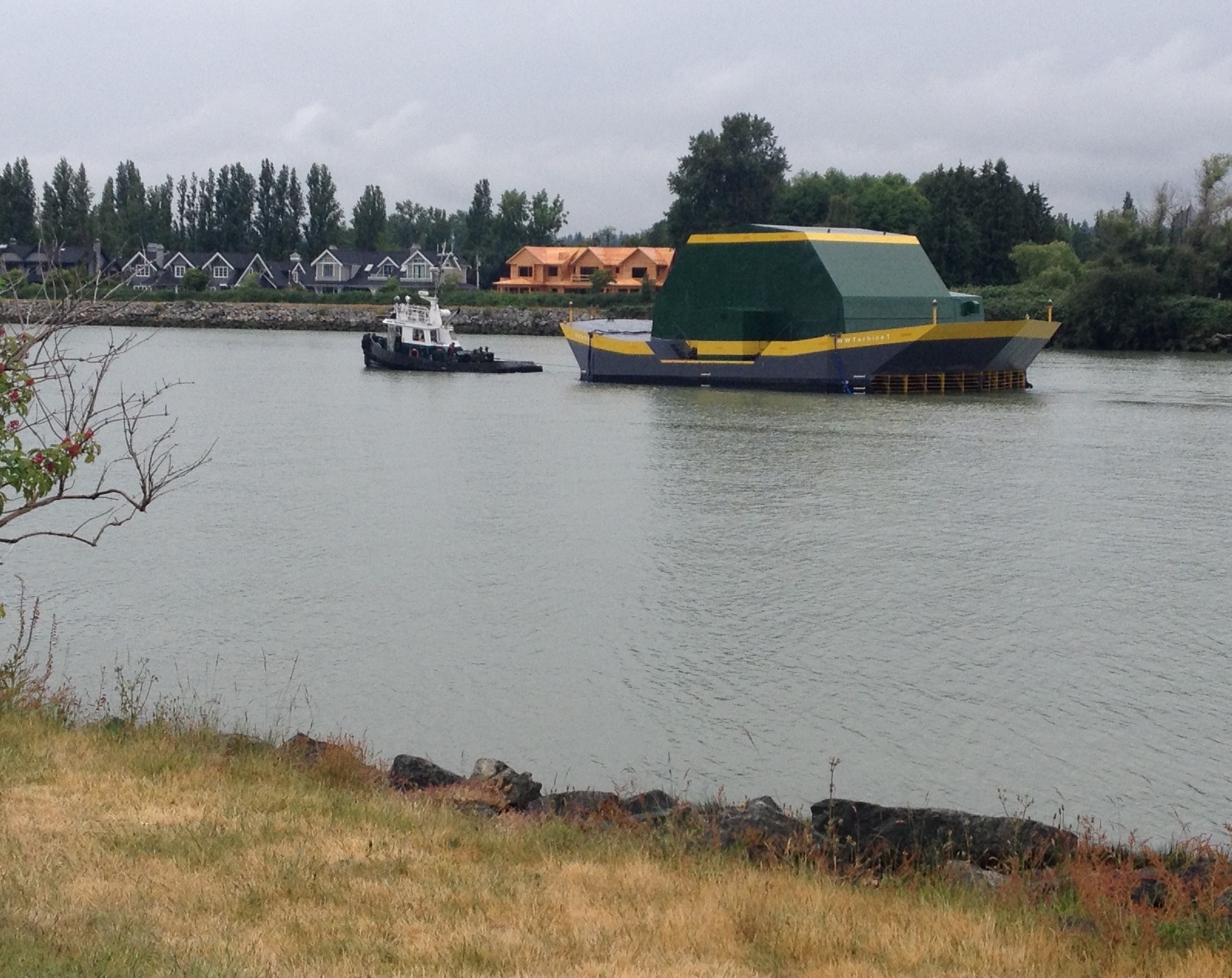 The Water Wall Turbine being towed from Richmond, BC along the North Arm of the Fraser River, towards Dent Island.