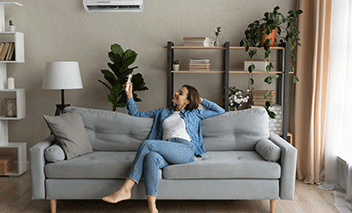 Woman turns on her air conditioner