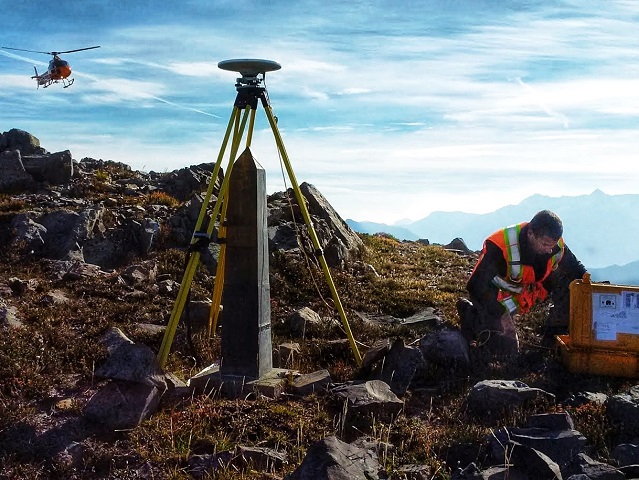 Boundary worker Karl Leblanc checks equipment during the survey through the Cascade Mountain Range at the B.C.–Washington border