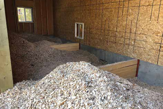 Wood chips are used as fuel in biomass boilers to heat ten community buildings.