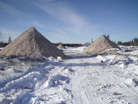 Wood chips from a biomass harvested site can be piled prior to transport to a bioenergy facility.