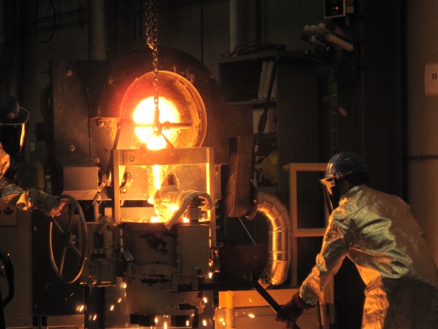 A man working with molten metal.